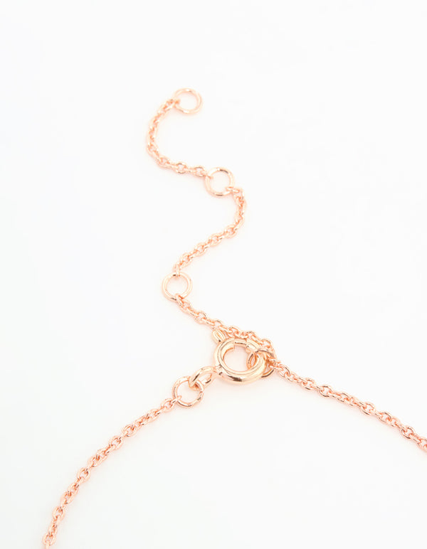 Highlighting the rose gold plated sterling silver bracelet with dainty bow charm design and adjustable closure detail view
