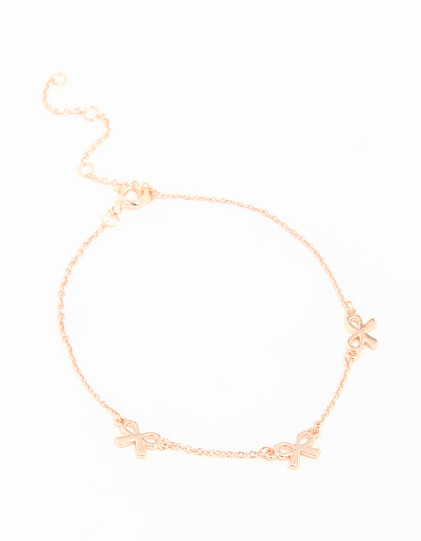Showcasing a rose gold plated sterling silver bracelet with dainty bow charm details in a delicate chain design front view