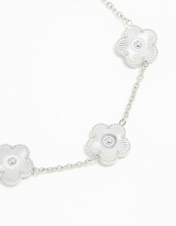 Featuring a waterproof stainless steel flower petal charm bracelet in silver close up view