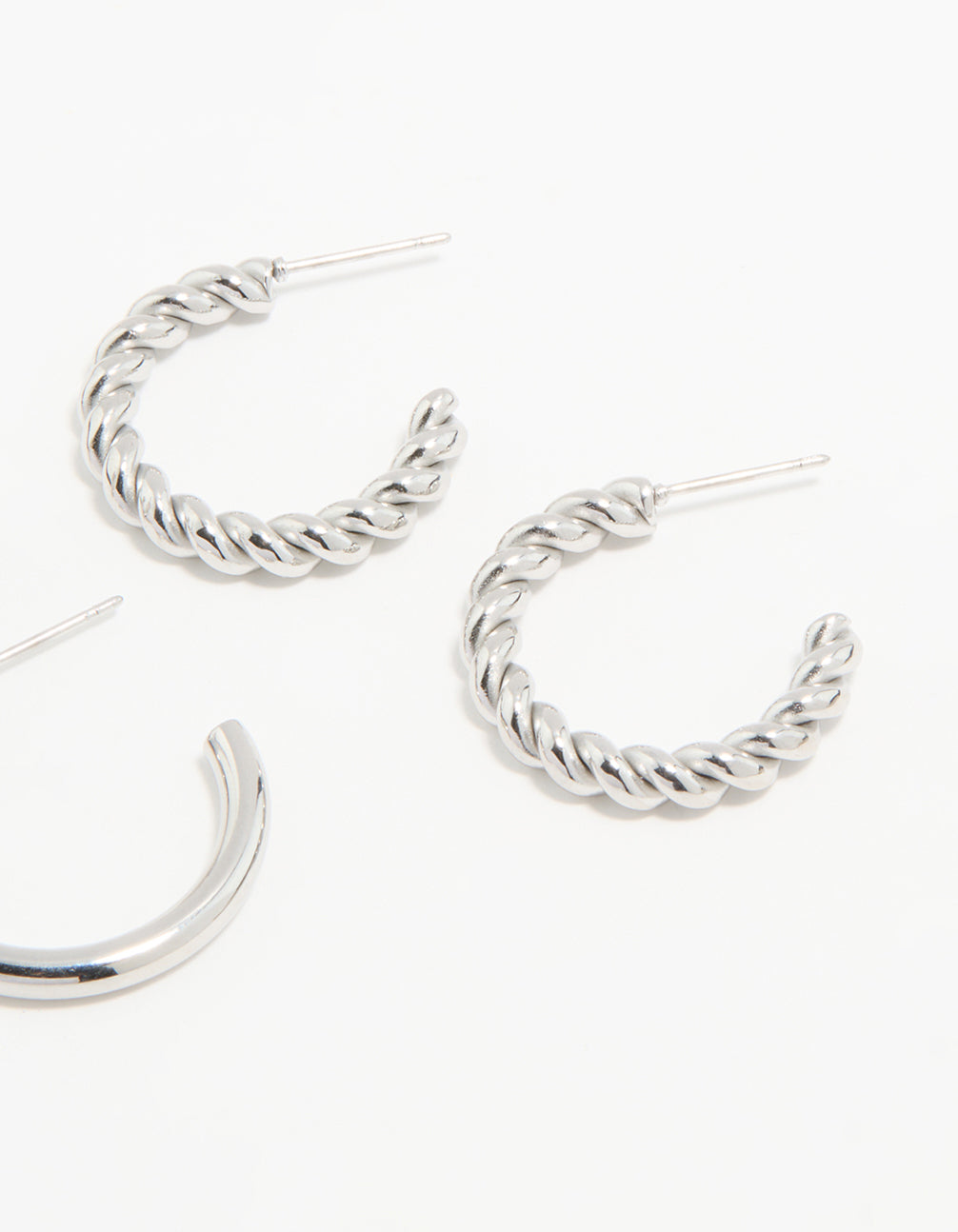 Featuring waterproof stainless steel construction, twisted and smooth hoop earrings in a 3-pack with silver tone post detail view