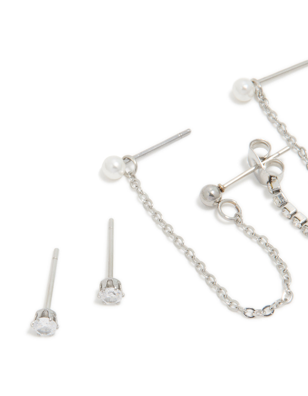 Featuring waterproof stainless steel cubic zirconia bow chain earrings with charm details and huggie closure in silver 3-pack close up view