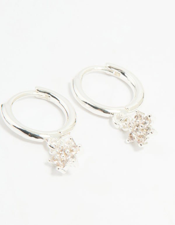 Presenting a flower hoop earrings from a 4-pack set with floral patterns crafted from cubic zirconia, crystal, and silver plated brass featuring stud and huggie closures in silver close up view