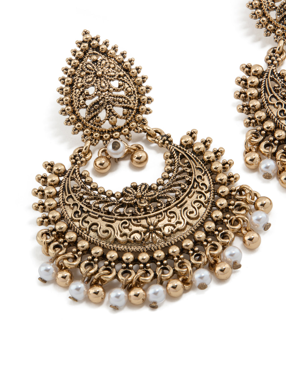 Showcasing antique gold teardrop pearl boho earrings with intricate beads, charm, and floral detailing close up view