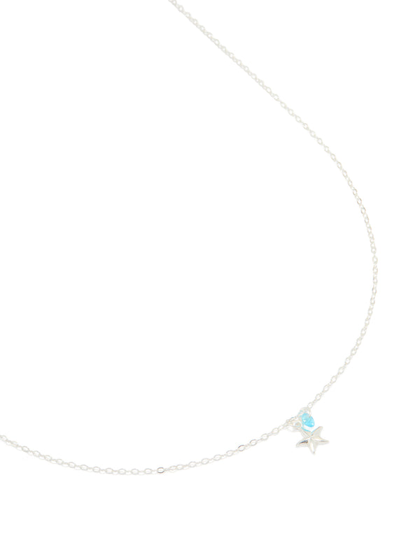 Crafted from sterling silver, this blue cubic zirconia and starfish pendant necklace features ocean-inspired charm details in a delicate crystal design close up view