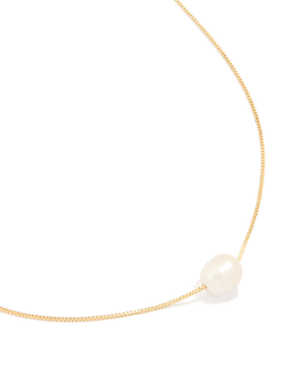 Featuring a gold plated freshwater pearl dainty snake chain necklace close up view