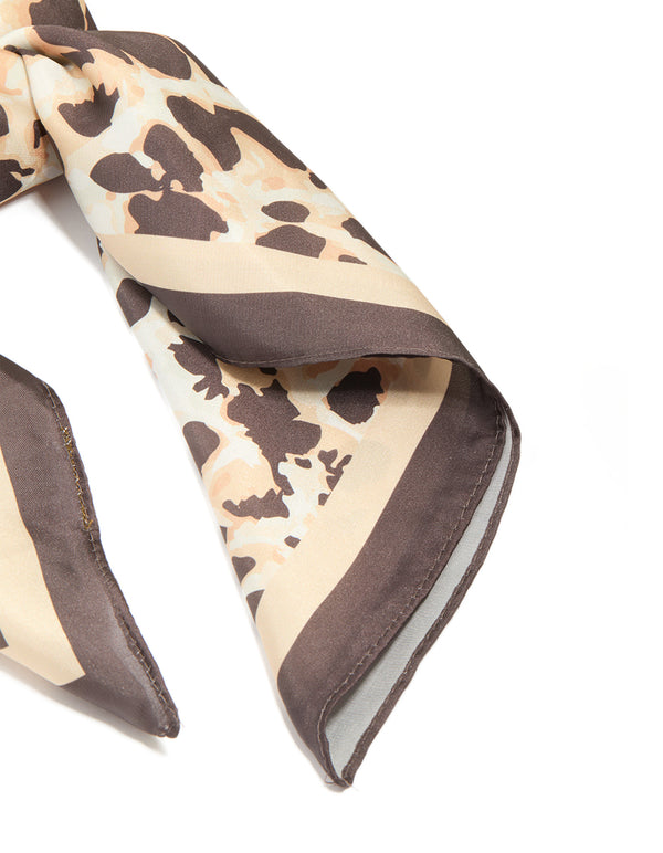Capturing a brown fabric scarf with animal print in tan and rosy brown side view