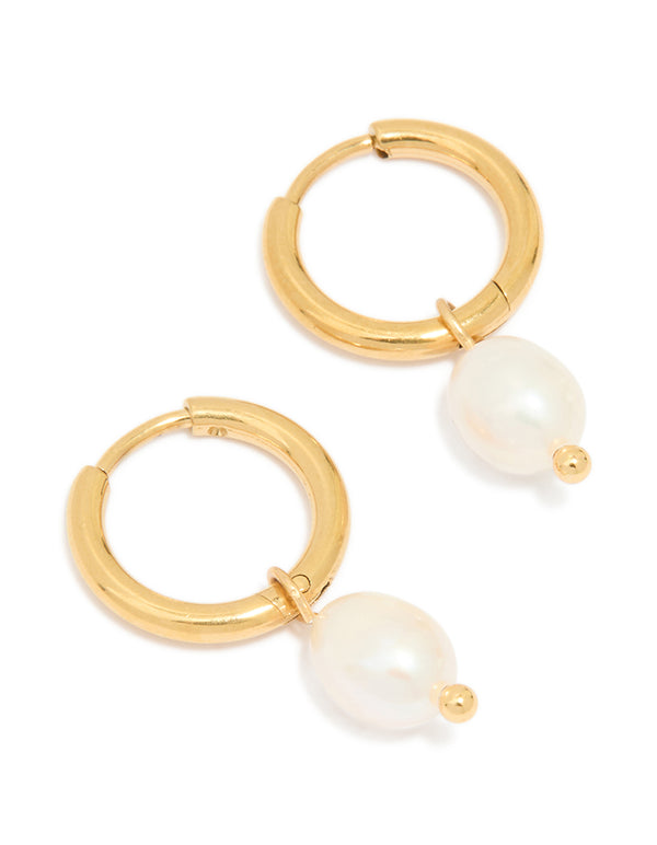 Showcasing waterproof gold plated stainless steel mini pearl drop charm huggie earrings in ivory front view