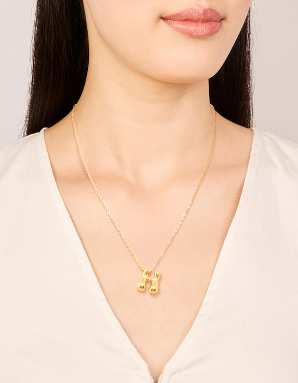Featuring a waterproof gold plated stainless steel bubble letter H initial pendant necklace on neck view