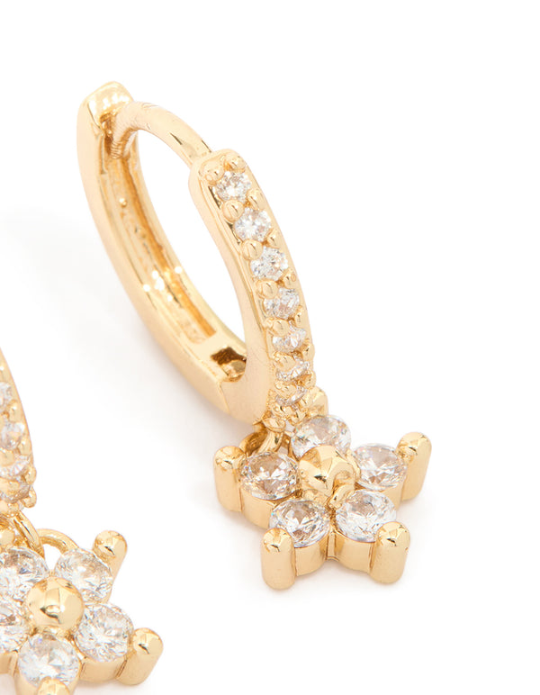 Designed with gold plated material and cubic zirconia stones, these flower pendant huggie earrings with huggie closure close up view