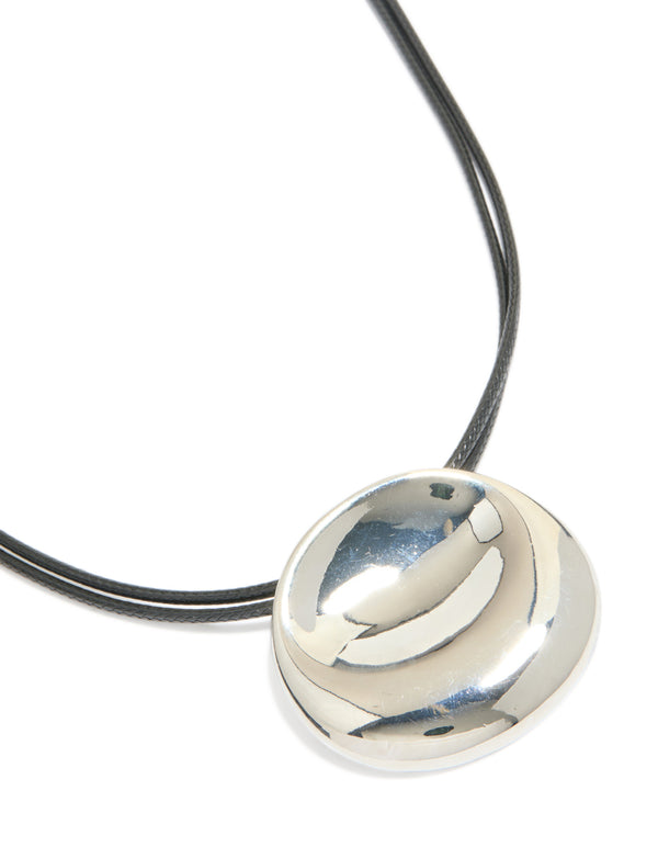 Showcasing a silver boho pendant cord necklace featuring statement design in black close up view