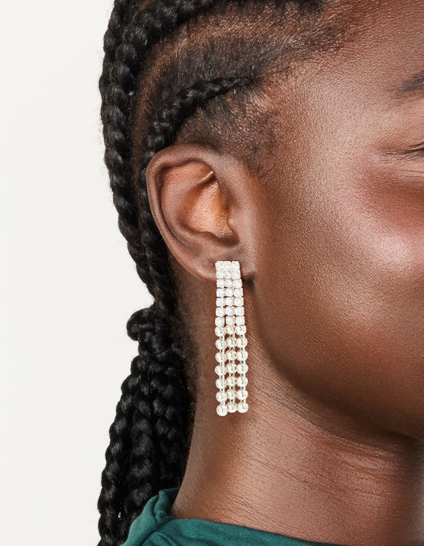 Discover silver cubic zirconia half cup chain drop earrings crafted from clear stones on ear view