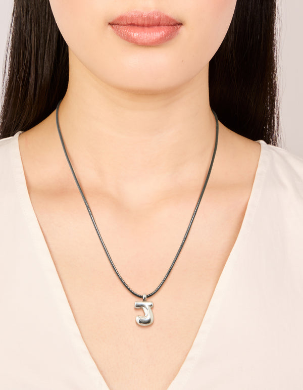 Featuring a waterproof stainless steel large bubble letter J grey cord dainty style necklace with initial pendant in silver on neck view