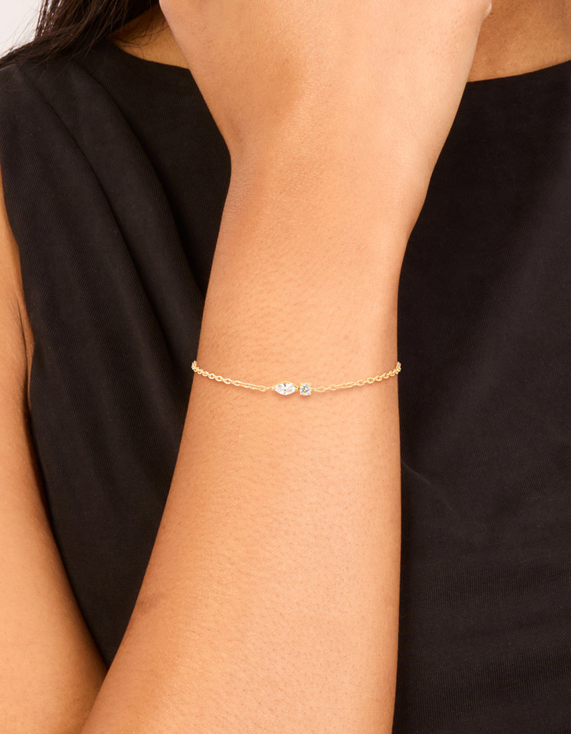 Featuring a waterproof gold plated stainless steel April cubic zirconia birthstone bracelet on wrist view