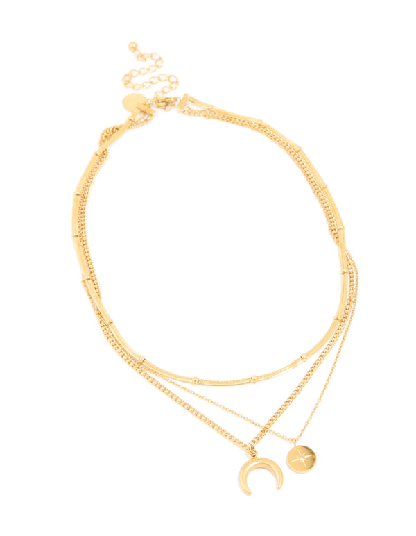 Elegantly displayed waterproof gold plated stainless steel layered necklace with celestial charm pendants featuring star, moon and balls front view