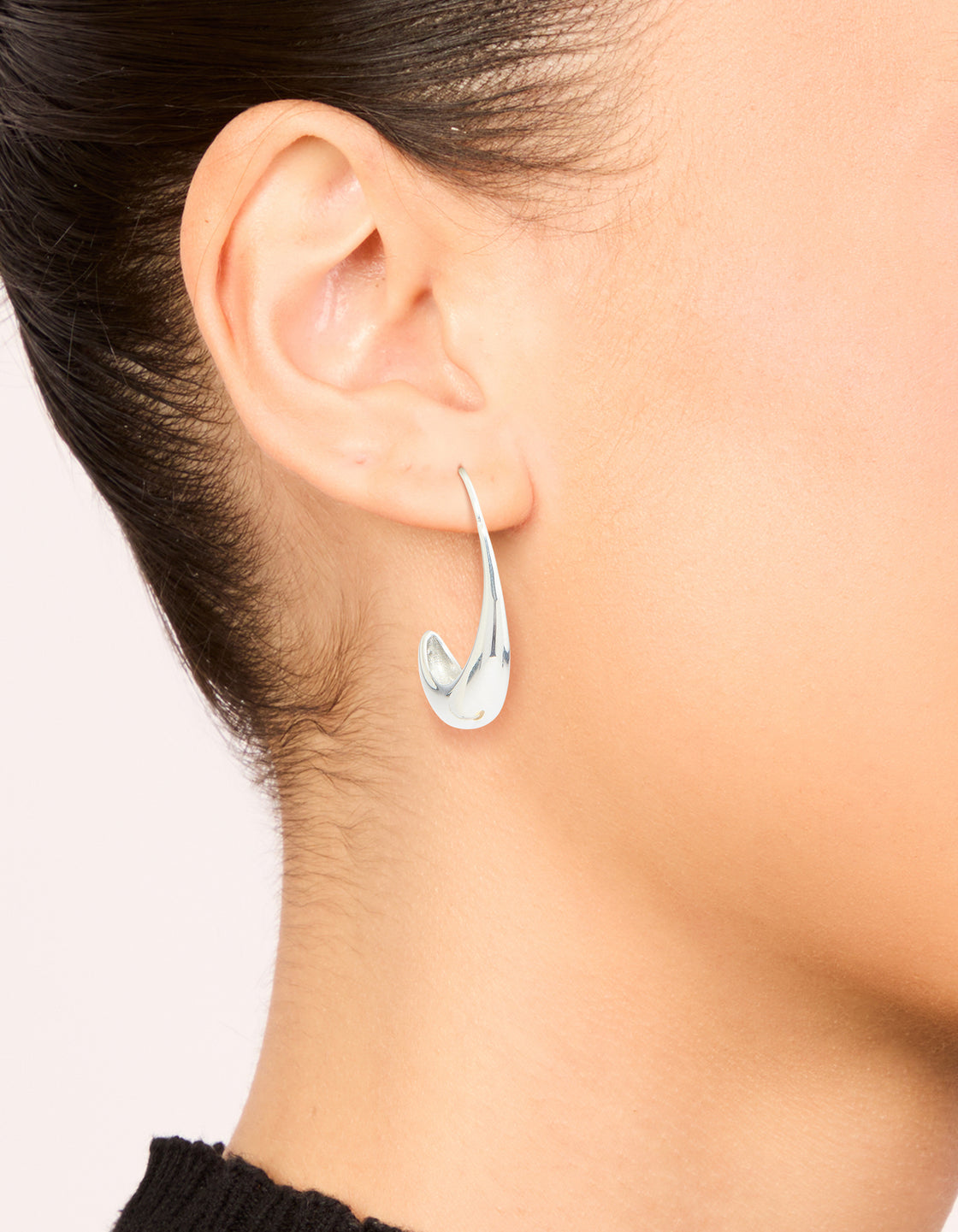 Featuring waterproof stainless steel thick half hoop earrings in silver on ear view