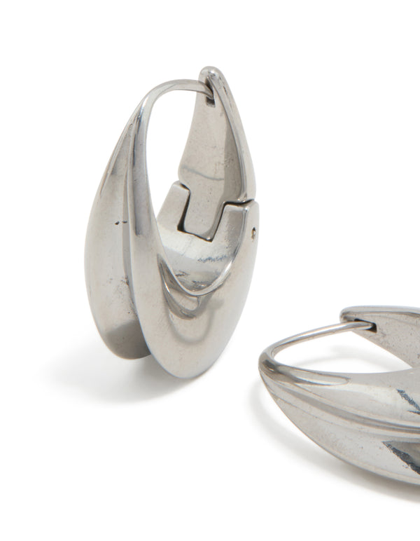 Displaying waterproof stainless steel oval concave huggie earrings in silver close up view