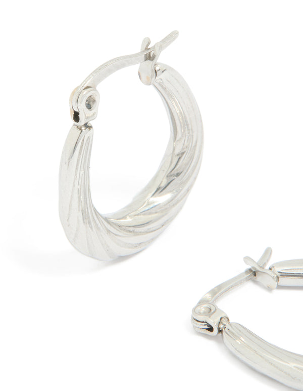 Designed with waterproof textured stainless steel oval hoop earrings in silver close up view