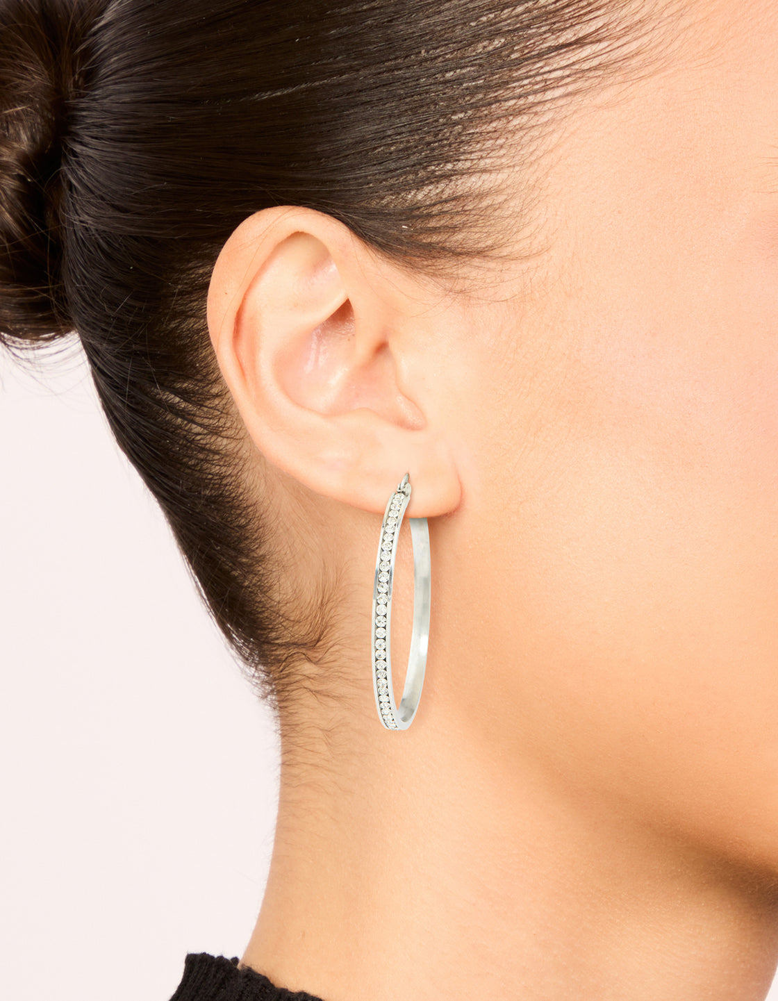Beautifully crafted waterproof stainless steel diamante hoop earrings in 45 MM with silver and clear tones on ear view