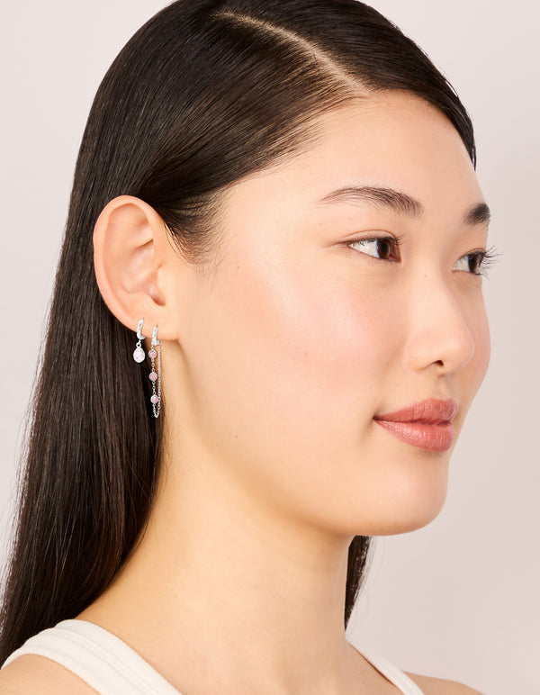 Elegant waterproof stainless steel pink cubic zirconia chain droplet and classic huggie earrings 2-pack in silver and light pink tones on model view