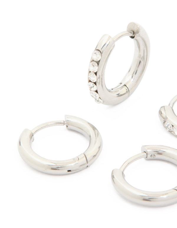 Designed with waterproof stainless steel, cubic zirconia and smooth chunky huggie earrings 2-pack featuring crystal embellishments in silver close up view
