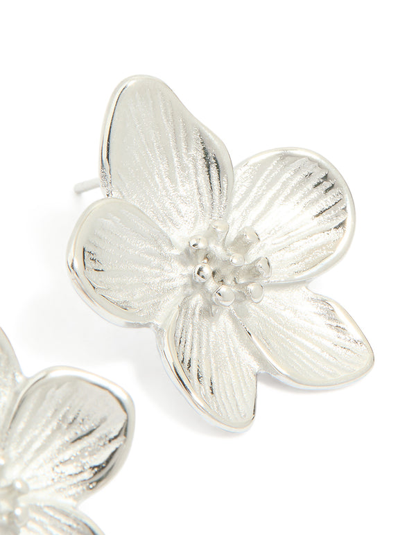 Highlighting mini textured flower earrings in waterproof stainless steel with floral pattern in silver post detail view