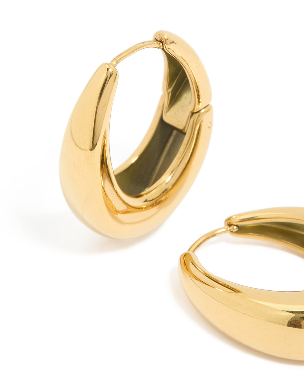 Displaying waterproof gold plated stainless steel oval hanging hoop earrings with closure mechanism close up view