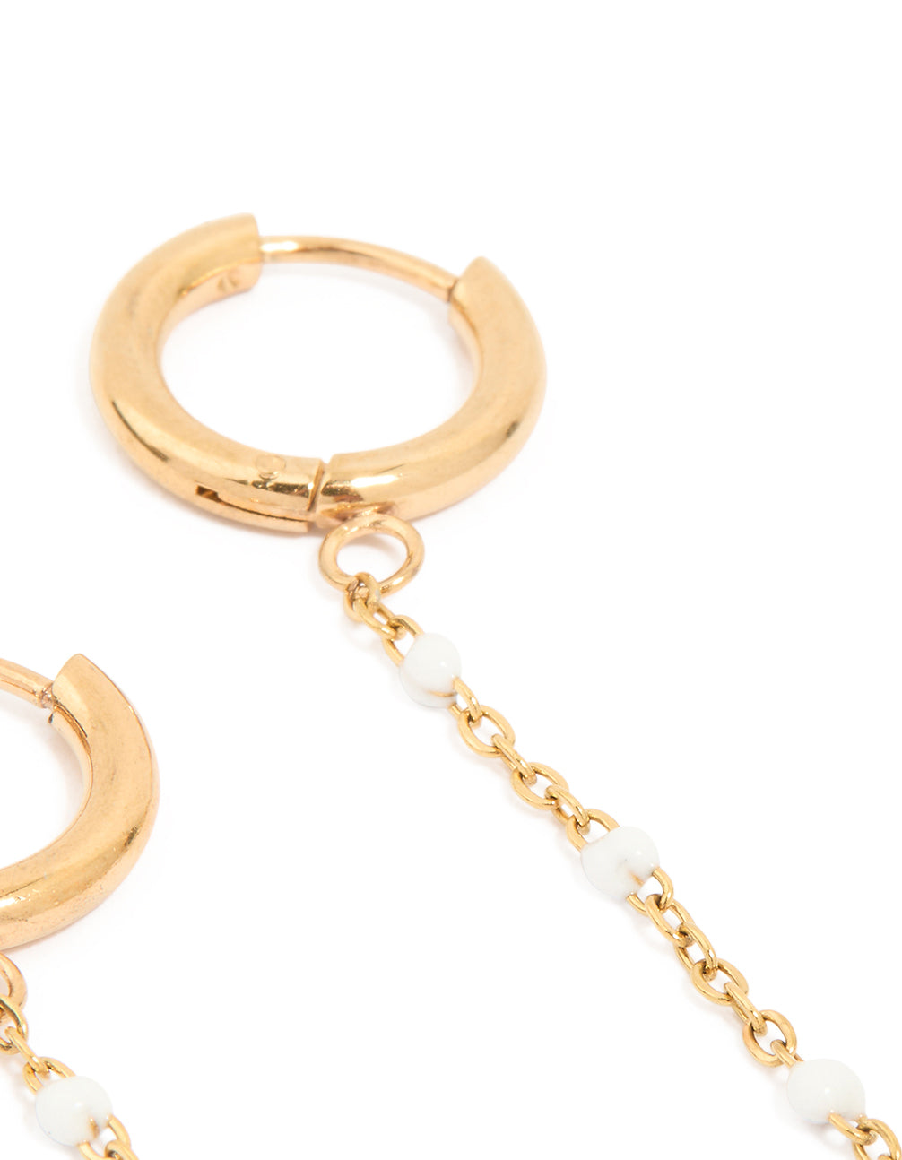 Highlighting waterproof gold plated stainless steel huggie earrings and freshwater pearl chain in white close up view