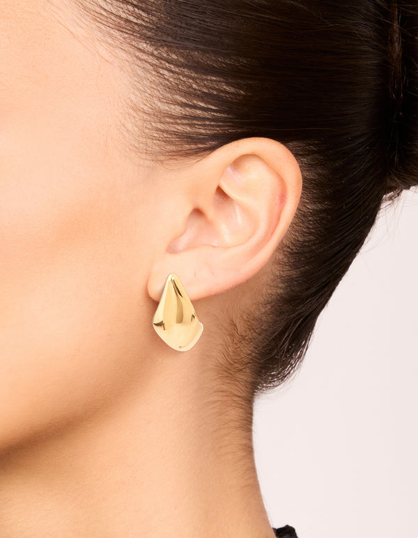 Showcasing waterproof button stud earrings in gold plated stainless steel on ear view