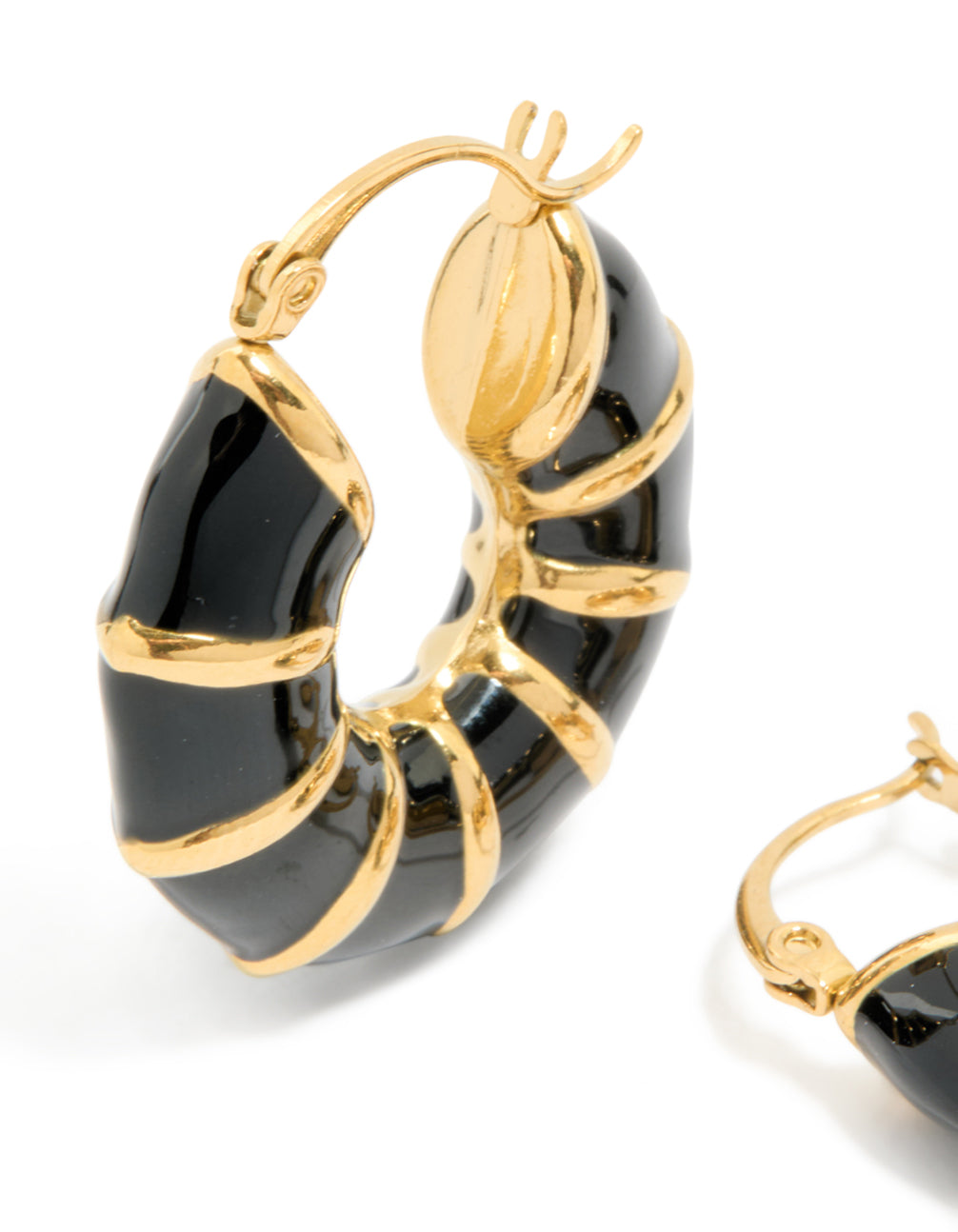 Crafted from waterproof stainless steel, these statement hoop earrings showcase black enamel bamboo detailing with plated finish in gold close up view