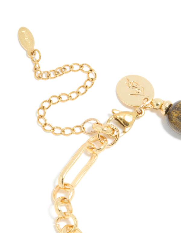 A waterproof gold plated stainless steel bracelet featuring beads, and tigers eye semi precious stone in brown closure detail view