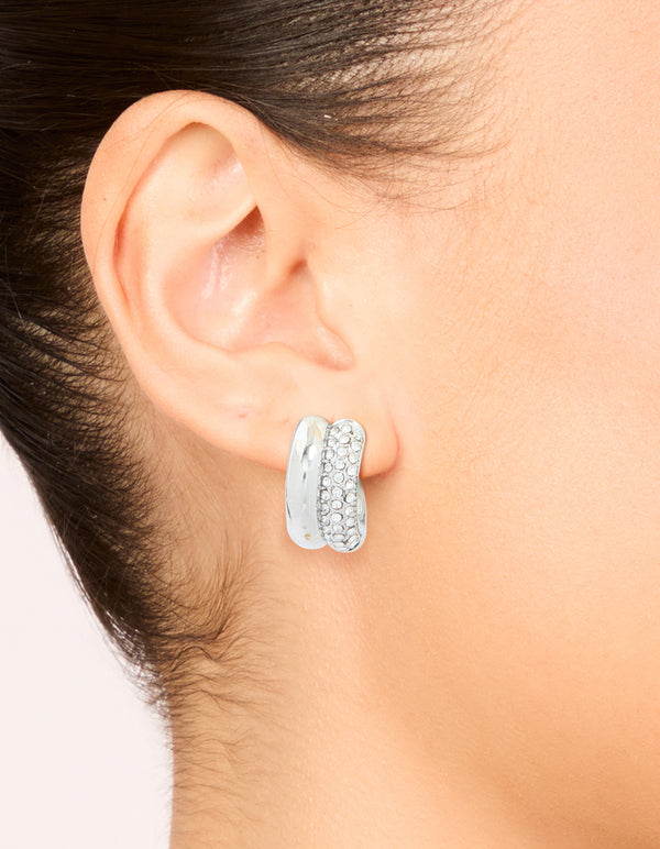 Featuring waterproof stainless steel cubic zirconia pave illusion hoop earrings in silver on ear view