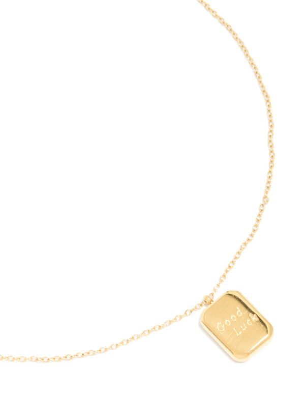 Highlighting a waterproof good luck pendant necklace in gold plated stainless steel featuring script with dainty design close up view