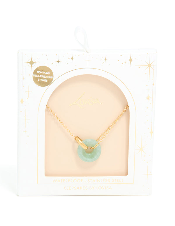 Explore a waterproof green acrylic doughnut necklace with gold plated stainless steel pendant shown in a packaging close up view