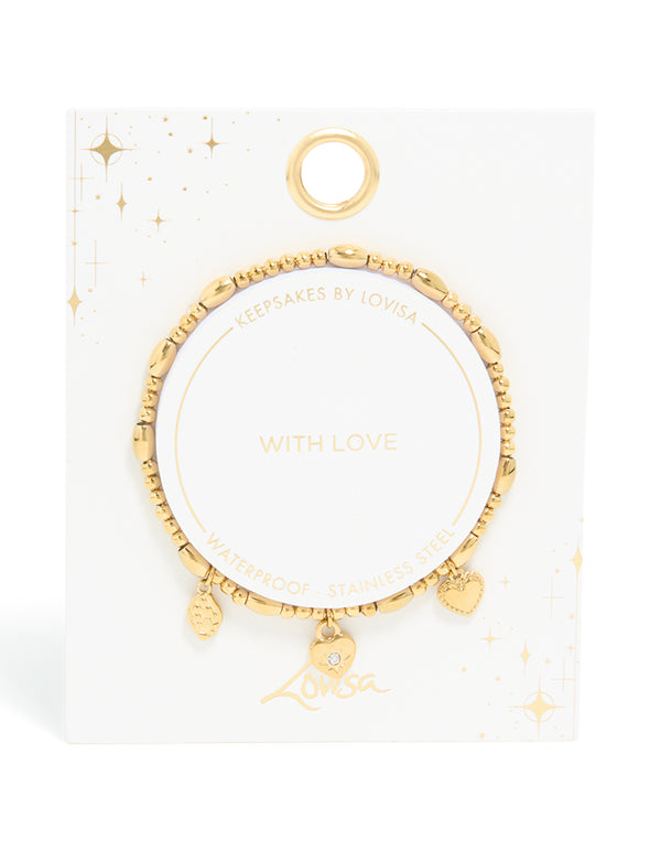Highlighting the intricate beaded, padlock, and charm details of this waterproof triple heart stretch bracelet, crafted from gold plated stainless steel, in close up view