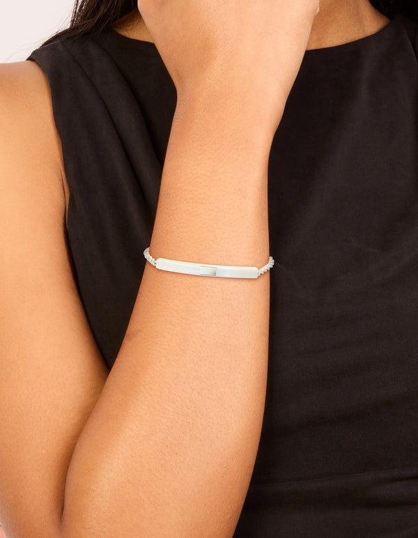 Showcasing a waterproof stainless steel twisted engravable toggle bracelet with bar detailing in silver on wrist view