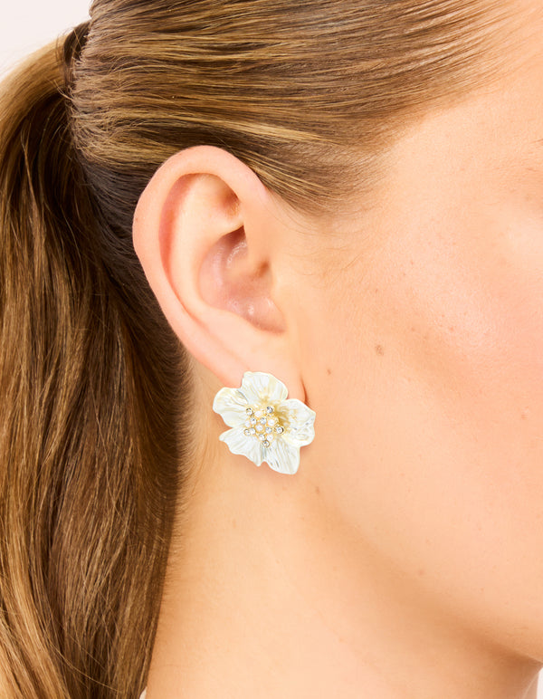 Showcasing statement floral earrings crafted from gold plated material featuring pearl and diamante accents in ivory on ear view