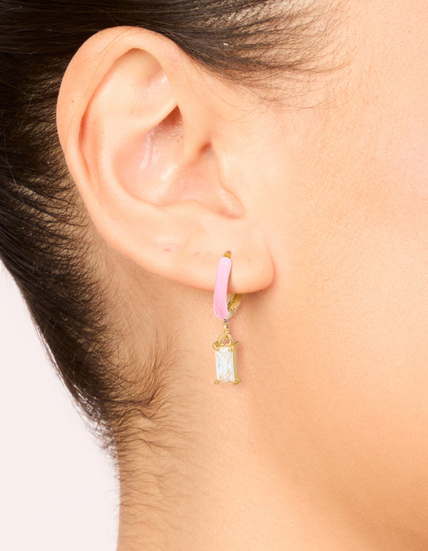 Featuring waterproof gold plated stainless steel pink enamel cubic zirconia charm huggie earrings on ear view