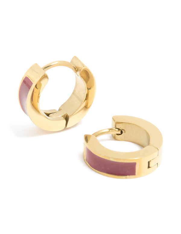 Crafted from waterproof gold plated stainless steel, these small statement huggie earrings feature burgundy red enamel inlay in front view
