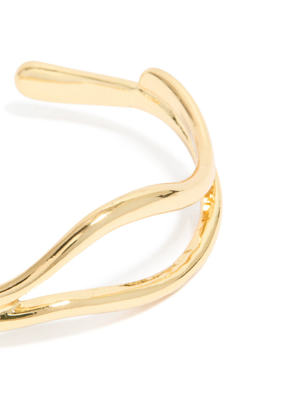 Showcasing gold plated organic open wave wrist cuff in close up view