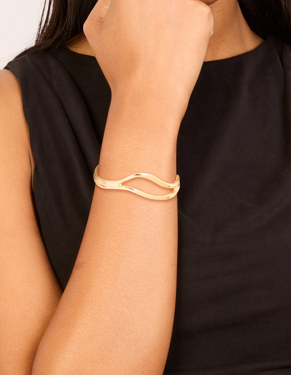 Beautifully crafted gold plated organic open wave wrist cuff on wrist view