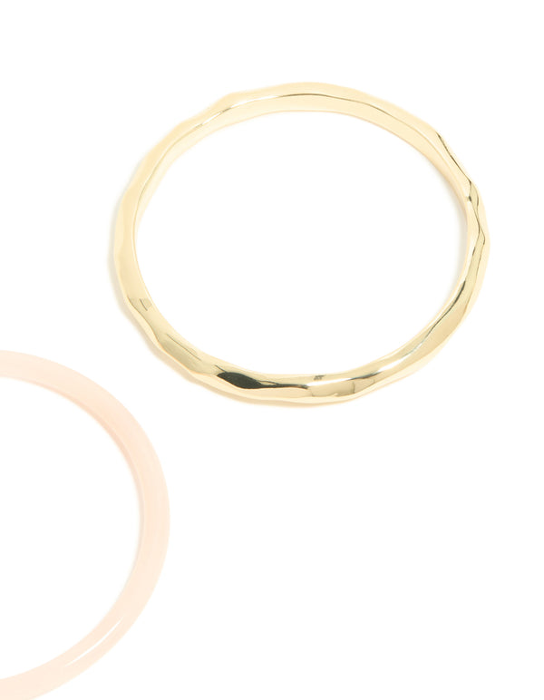 Crafted from gold plated material with pink acrylic, this statement bangle 2-pack close up view
