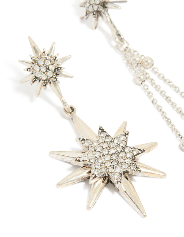 Featuring antique silver diamante asymmetrical star and moon drop earrings with celestial charm statement design close up view