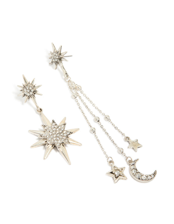Showcasing antique silver diamante asymmetrical star and moon drop earrings with celestial charm statement design front view