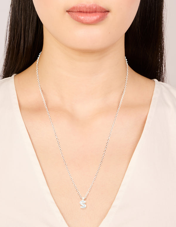 Featuring initial bubble letter S in waterproof stainless steel silver, this dainty necklace is shown on neck view