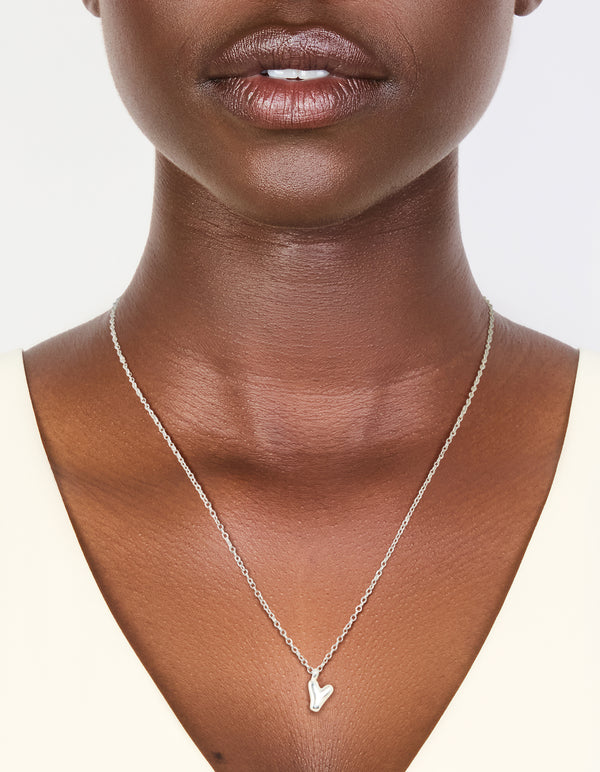 Crafted from waterproof stainless steel mini bubble letter Y necklace with initial pendant in silver on neck view