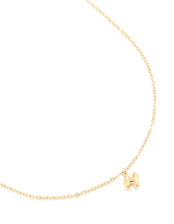 Showcasing a waterproof bubble letter H necklace crafted from gold plated stainless steel with initial pendant close up view