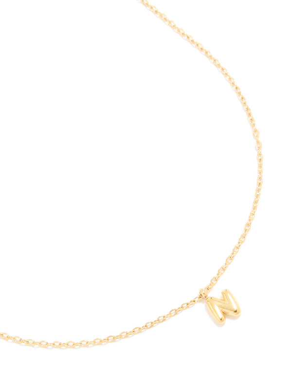 Showcasing a waterproof bubble letter N initial pendant necklace crafted from stainless steel with gold plated finish close up view