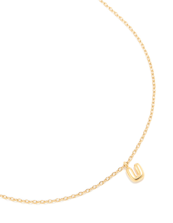 Showcasing a waterproof bubble letter U initial pendant necklace in gold plated stainless steel with a dainty style close up view