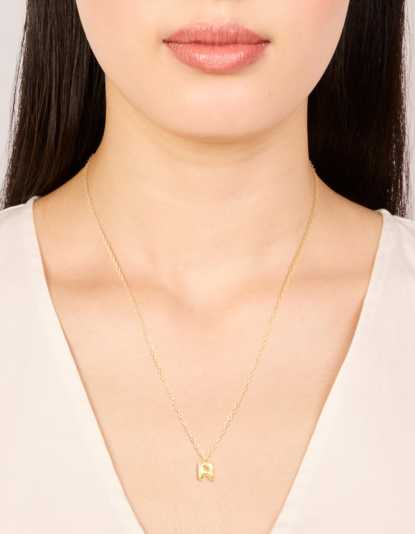 Discover the waterproof gold plated stainless steel mini bubble letter R initial pendant necklace with dainty styling on neck view