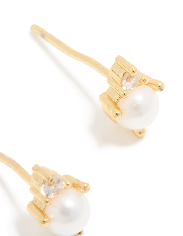 Crafted from waterproof gold plated stainless steel, June cubic zirconia duo stud earrings with pearl details post detail view